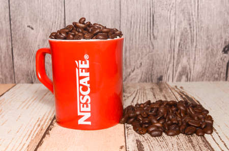 Puchong, Malaysia - February 26, 2019; Nescafe mug with coffee bean on wooden background. Selective focus.のeditorial素材