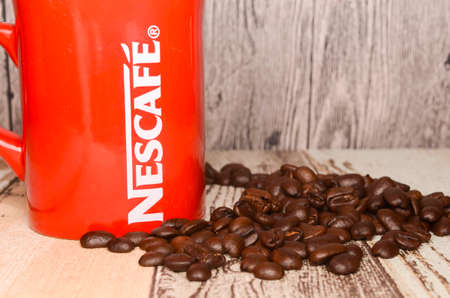 Puchong, Malaysia - February 26, 2019; Nescafe mug with coffee bean on wooden background. Selective focus.のeditorial素材