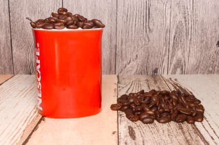 Puchong, Malaysia - February 26, 2019; Nescafe mug with coffee bean on wooden background. Selective focus.のeditorial素材