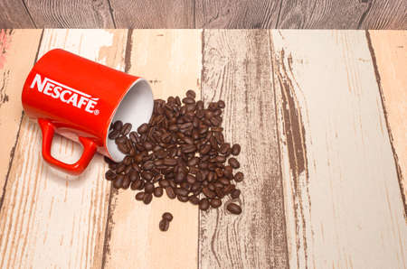 Puchong, Malaysia - February 26, 2019; Nescafe mug with coffee bean on wooden background. Selective focus.のeditorial素材