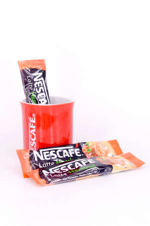 Puchong, Malaysia - February 25, 2019; Sachet of instant Latte Hazelnut with Nescafe mug on white...