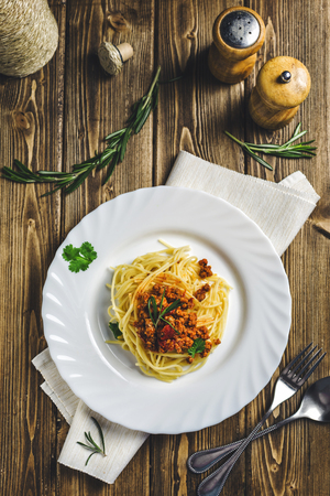 pasta Bolognese with rosemary on wooden backgroundの写真素材