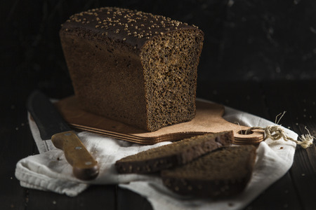 Black sourdough bread with cumin, without flour, good for health. On a wooden background. The view...