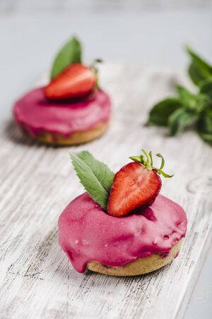 doughnuts strawberry glaze on a light background closeup with copyspaceの写真素材
