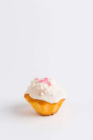 Muffin with chocolate icing and jam on a white background, isolated. Close-up with a copy space for the text.の写真素材