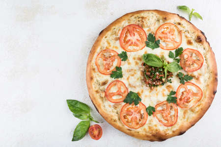Pizza with chicken and garlic, Caesar sauce, pork, tomatoes and Mozzarella cheese on a light...