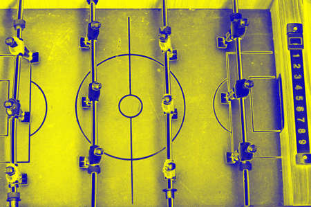 Table football game with yellow and blue players. Yellow