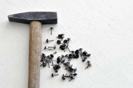 Hammer and nails on a wooden table. concept for designerの写真素材