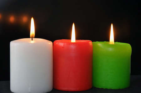 Colorful burning candles set on blackの写真素材