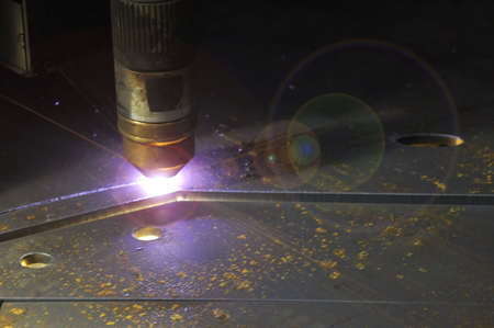 laser cutting torch machine in an industrial plant cuts sheet metal. Industry