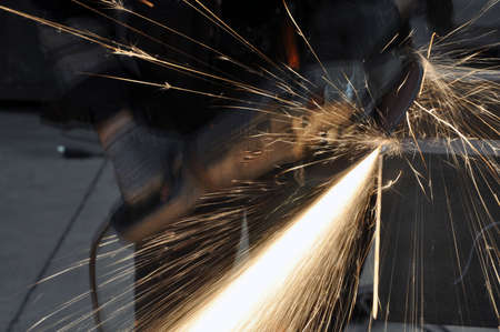 angle grinder. Worker at the factory cuts metal. sparks fly