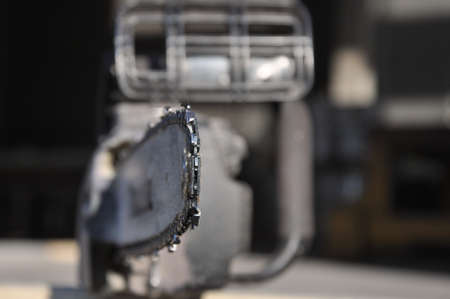 Chainsaw. Close-up of saw chain with residues of sawdust and wood dust. The concept is to cut down trees.の写真素材