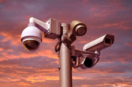 closed circuit camera Multi-angle CCTV system. against a red sky with sunsetの写真素材