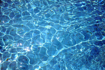 Swimming pool bottom caustics ripple and flow with wavesの写真素材