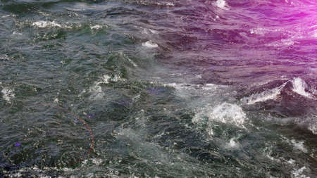 Water of a fast mountain river with rapids.の写真素材