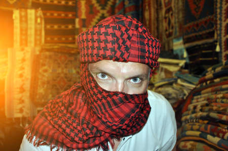 A young handsome man in a turban stares intently at you.の写真素材