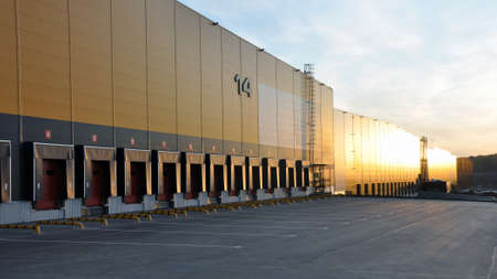 October 3, 2019 - Moscow, Russia: Modern warehouse complex. View of loading docks in the rays of the...