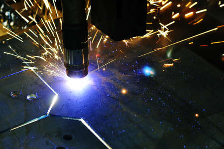 Laser cutting of metal with CNC, modern industrial technology. Shallow depth of field. Warning -...