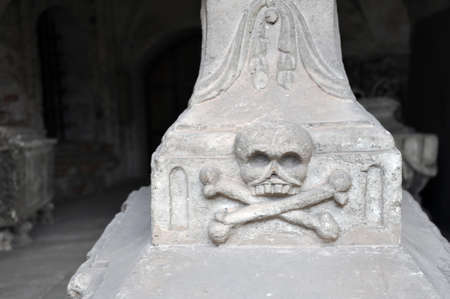 Skull and crossbones on a tombstone of the nineteenth century, bas-relief.の写真素材