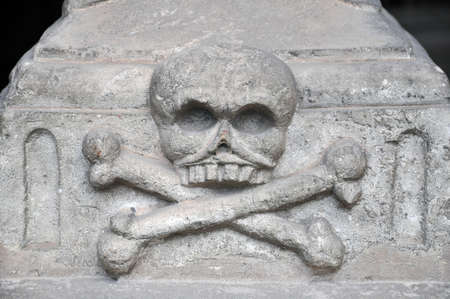 Skull and crossbones on a tombstone of the nineteenth centuryの写真素材
