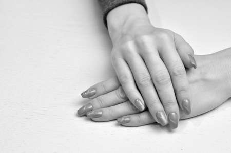 Hands with red manicure on a white background. Beauty and Fashionの写真素材