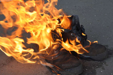 Burning shoes close-up. Burning work shoes shoes. Special shoes on fire.の写真素材