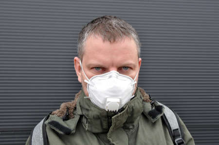 A man in a jacket with a mask to protect him from the coronavirus. Corona virus pandemic. Crown Health.の写真素材