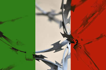 The Italian flag is bound with barbed wire.の写真素材