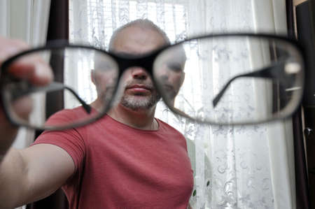 Close the glasses against the background of the person looking at them. Lens distortion.