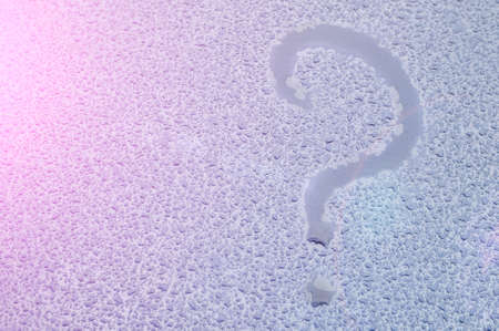 Question mark. The inscription on a wet metal surface. In the summer rainの写真素材