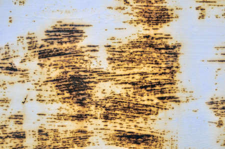 Rusted white painted metal wall. Rusty metal background with streaks of rust. Rust stains. The metal...