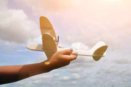 Toy plane in the sky. Game in the open air. Aviation