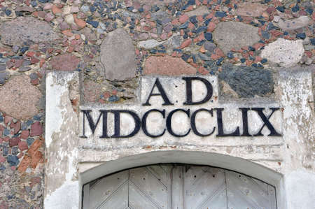 Kossovo, Belarus - July 15, 2020: Neo-Gothic style chapel in the old Catholic cemetery. Inscription above the entranceの写真素材