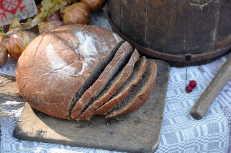 Still life with a chopped hearth black bread. In bright sunlightの写真素材