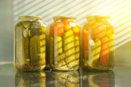 Home canning of vegetables from a backyard garden in glass jars. Processing tomato harvest from a home garden.の写真素材