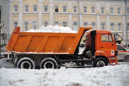 Snow removal from the city streets is heavily loaded with transportの写真素材