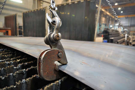 Lifting chains and hooks for loading sheet metal. Placing metal on a plasma cutting machine for...