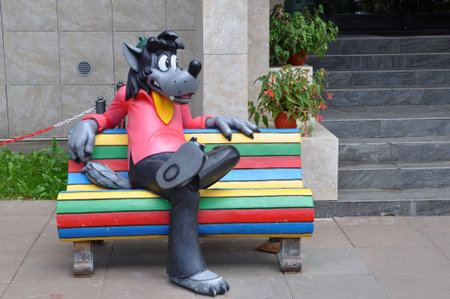 Moscow, Russia - May 30, 2021: sculpture of a wolf on a bench from a Soviet cartoon in front of the Soyuzmultfilm film studio.のeditorial素材