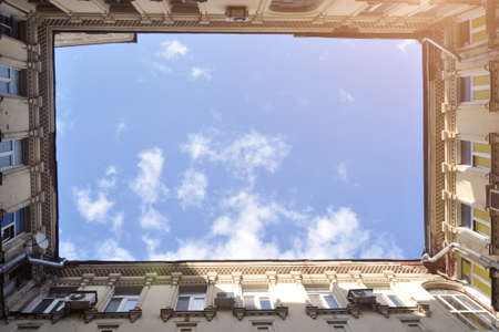 Well yard. A look from the depths of the courtyard to the sky. Unusual urban architecture.