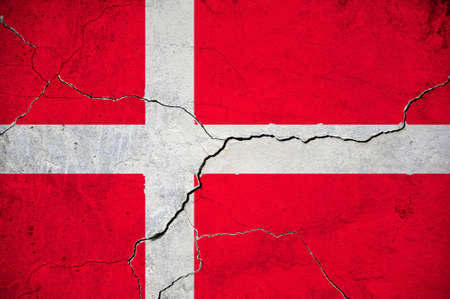 An image of the flag of Denmark on a wall with a crack. Background.の写真素材