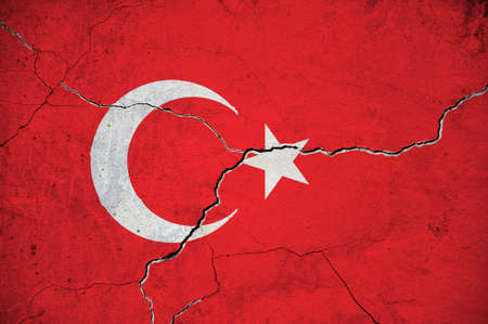An image of the flag of Turkey on a wall with a crack. Background.の写真素材