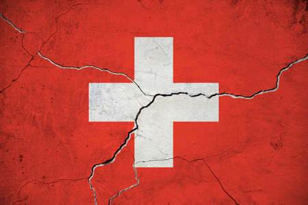 An image of the Switzerland flag on a wall with a crack. background.