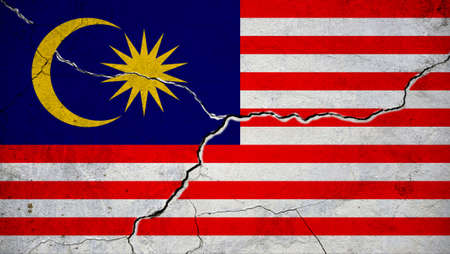 An image of the Malaysia flag on a wall with a crack. background.の写真素材