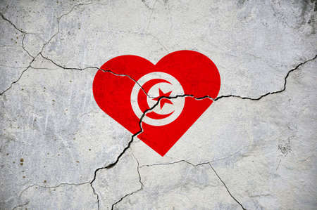 The symbol of the national flag of Tunisia in the form of a heart on a cracked concrete wall. concept.の写真素材