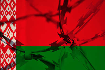 Abstract image of the national flag of Belarus with twisted barbed wire. Repression.の写真素材