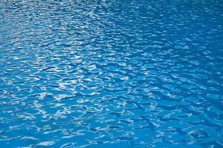 Pool water surface. Trendy abstract nature background. Water waves in sunlight with copy space.