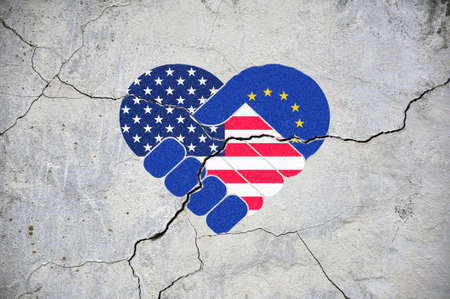 The symbol of close friendship cracks. Heart in colors of national flags of European Union and USA. concept.の写真素材