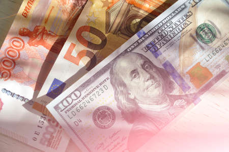 100 US dollars banknote next to 50 euros and 5000 Russian rubles. world currencies. Euro trading...