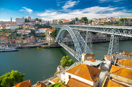Aerial view of Ponte Luis Bridge over Douro River, tiled roofs of colorful buildings and old historic district Ribeira in Porto Oporto city, Portugalの写真素材