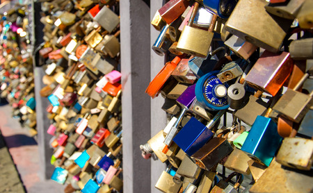 Many colourful closed locks on the Bridge of love in Helsinki, Finlandの写真素材
